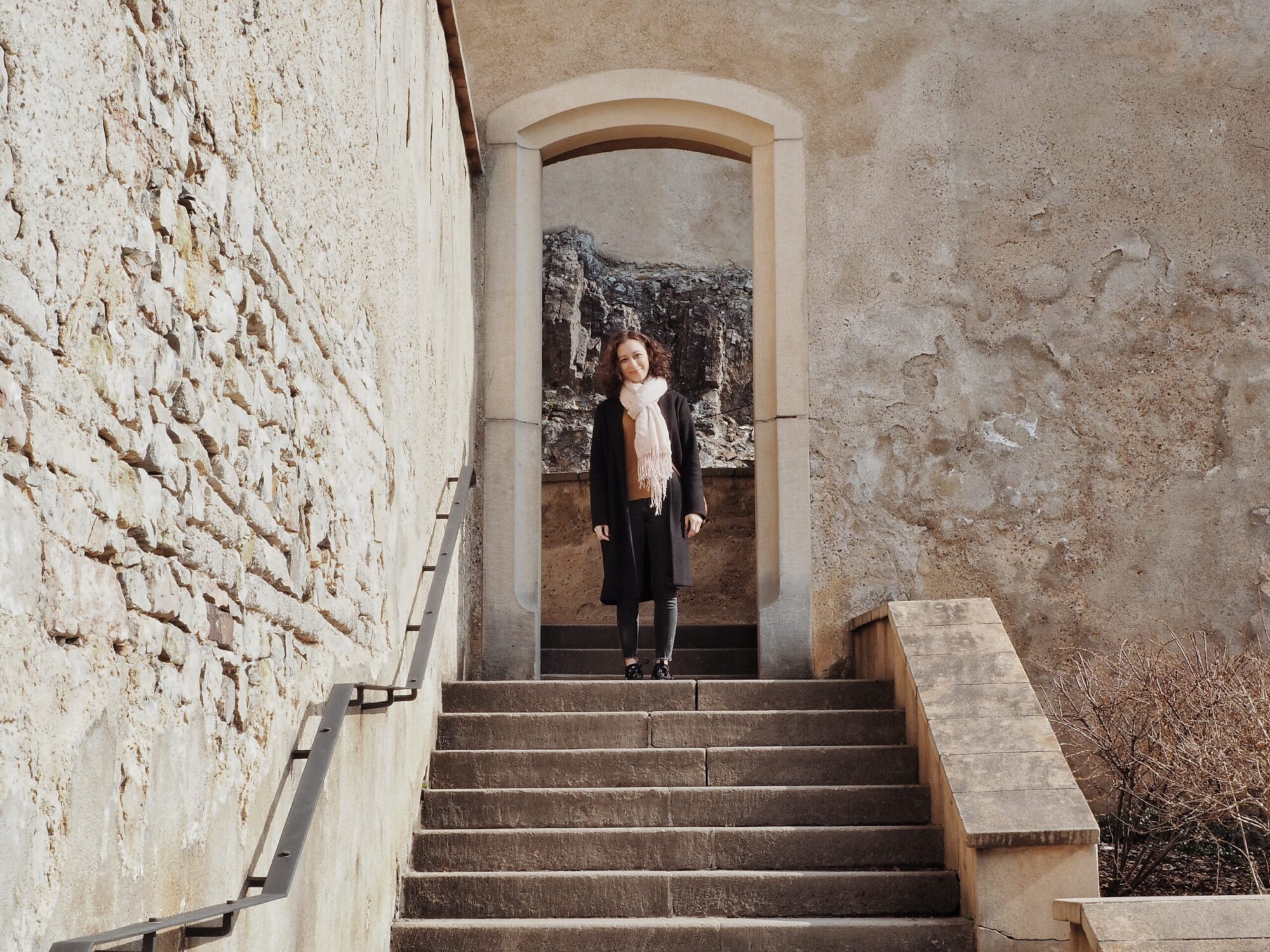 Exploring and smiling for the camera in a castle in prague